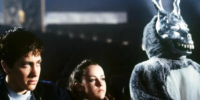 A scene from Donnie Darko with Frank, Donnie, and Gretchen in a cinema