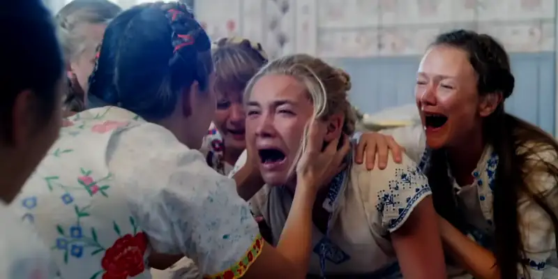 Dani, the main character in Midsommar, screaming during a ritual with other women in the cult