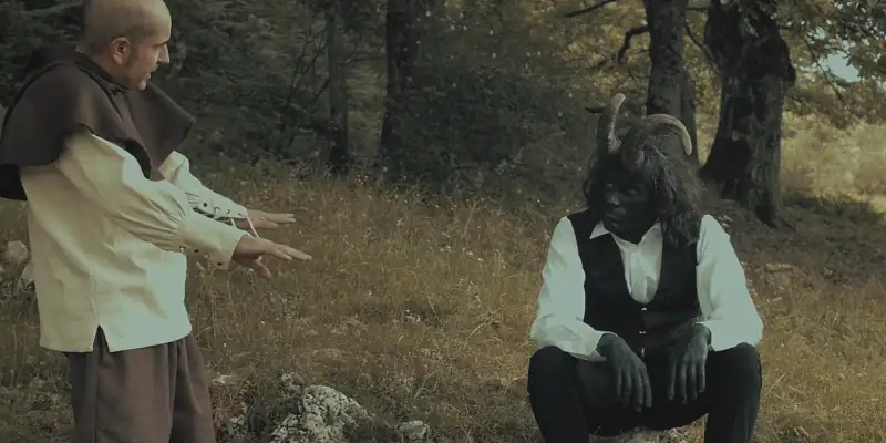 Andruccio talking to his mysterious horned companion in a forest during a scene from Mirtillo Numerus IX
