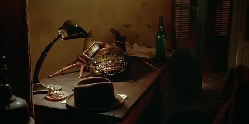 A scene from Naked Lunch showing a typewriter that has morphed into a giant beetle